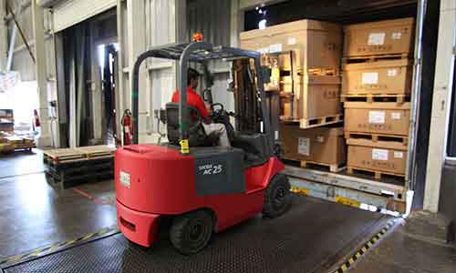 Forklift moving freight in a warehouse